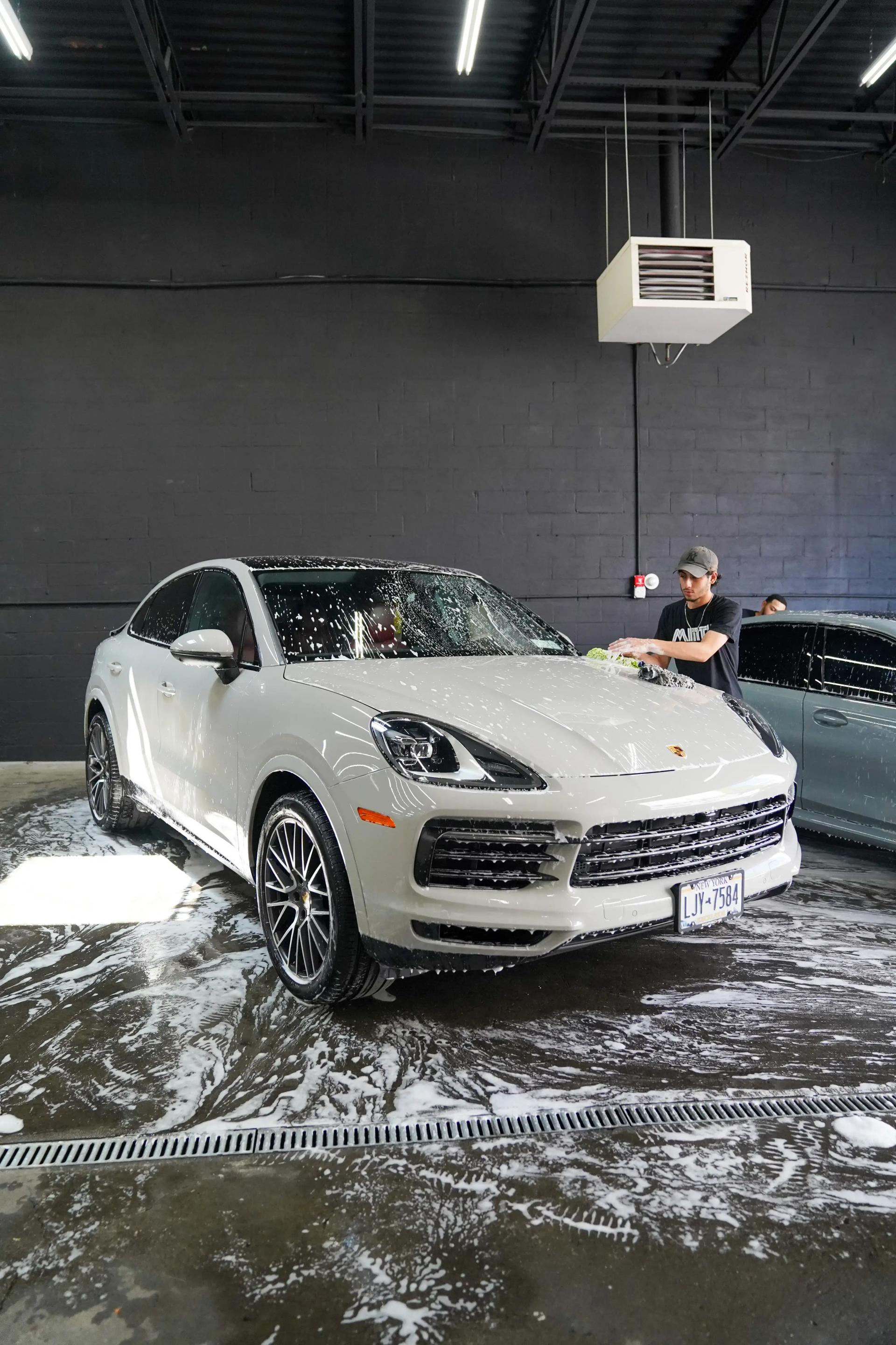 Professional detailing service on luxury Porsche - Multi-stage paint correction and premium leather conditioning